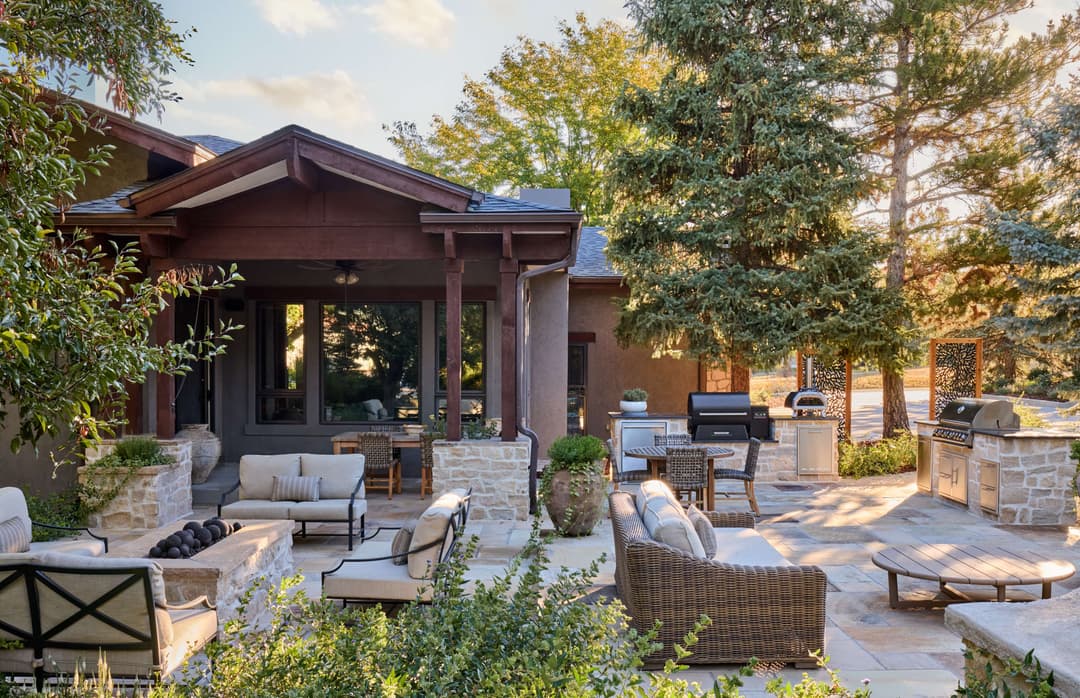 Cozy outdoor patio with seating, grill, and surrounding greenery in a serene setting.